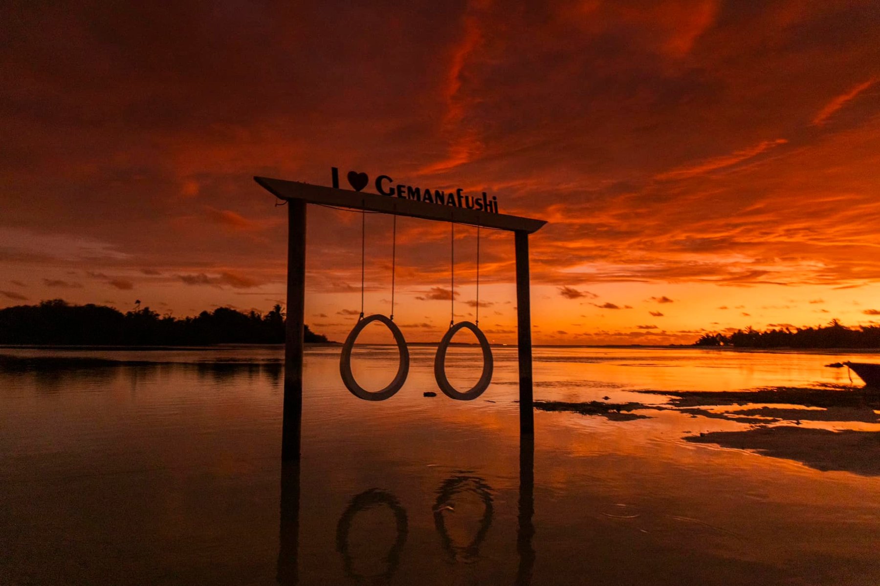 Rings swing over the water at sunset on Gemanafushi