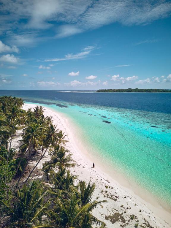 Aerial view of a sandbank and turquoise lagoon on Kondey