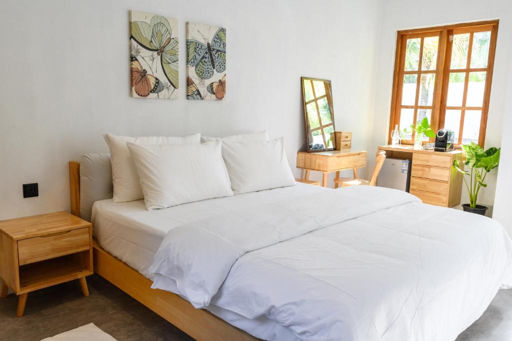 A bright, simple bedroom at the Kondey villa stay
